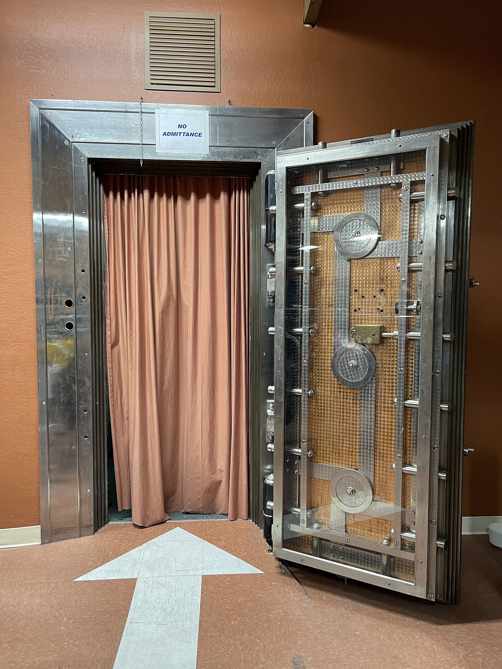Open bank vault door with a heavy bolt frame