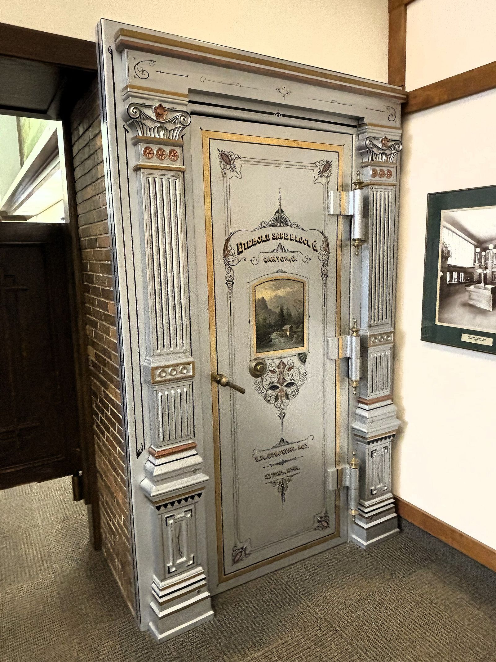 Ornate steel vault door with gilded decoration