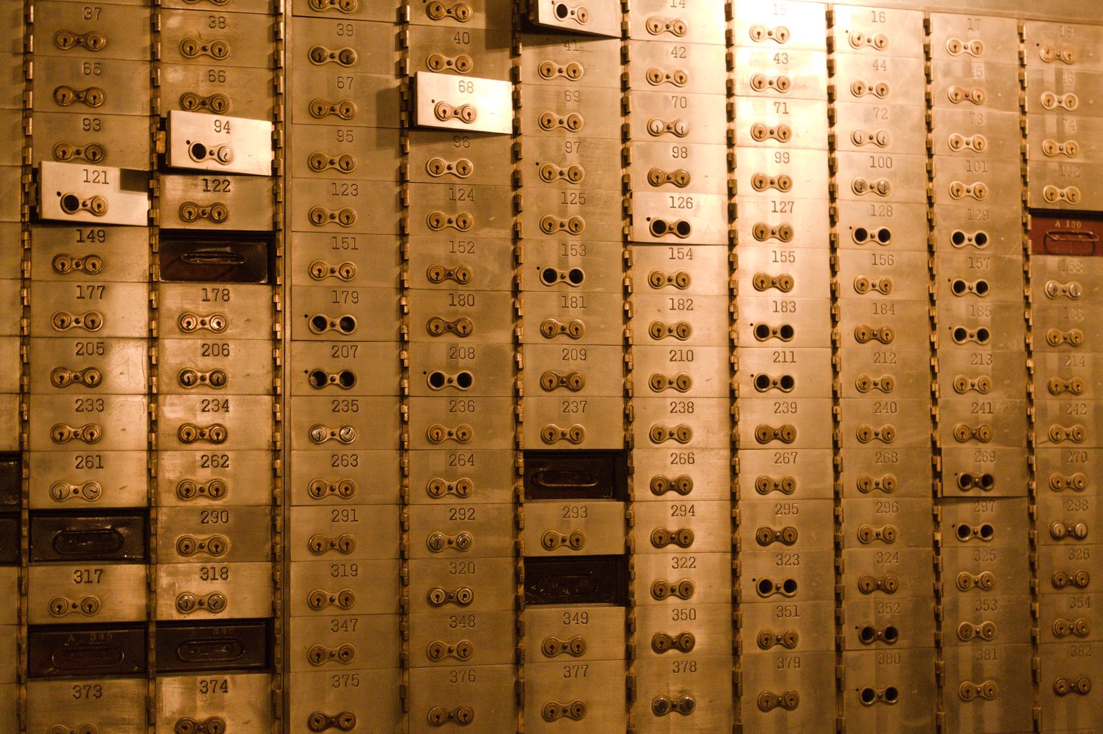 Wall of numbered brass safe deposit boxes